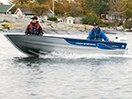 Two people in a moving fishing boat 