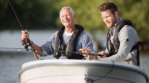 Two men fishing and smiling